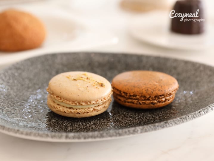 A plate of macarons in different flavors displayed on a table
