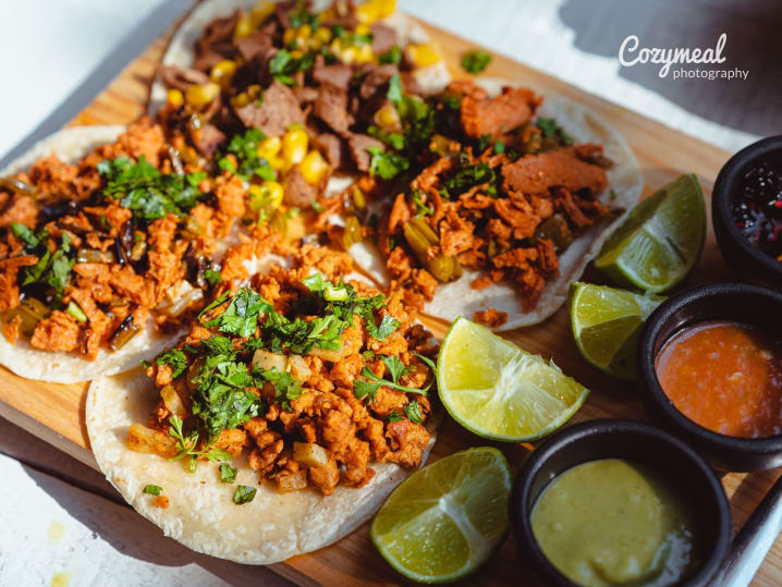 authentic Mexican rice and beans served on white plate with lime slices