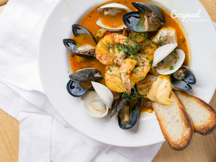 Bouillabaisse top view with toasted bread on the side