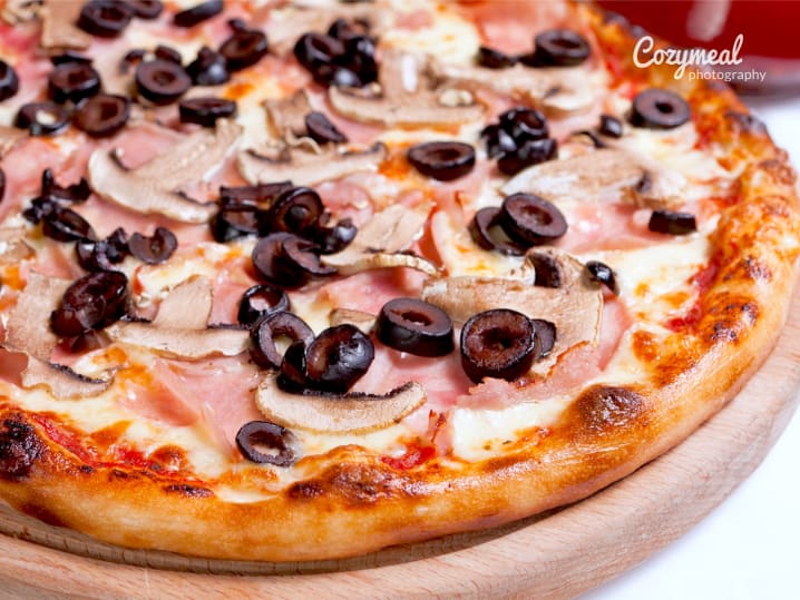 Capricciosa pizza with salami, mushrooms and black olives