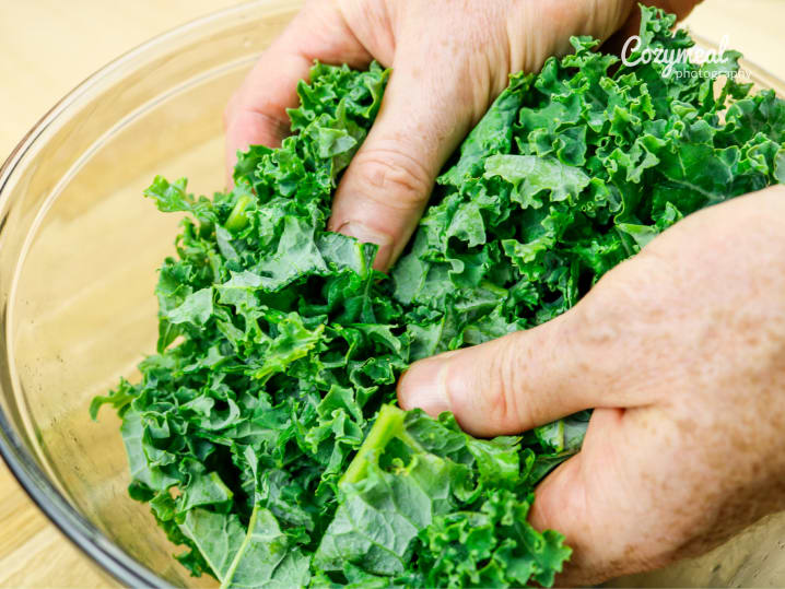 Chef massaging fresh kale