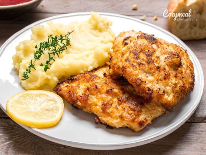 Chicken Milanese with potato mash on the side and a slice of lemon