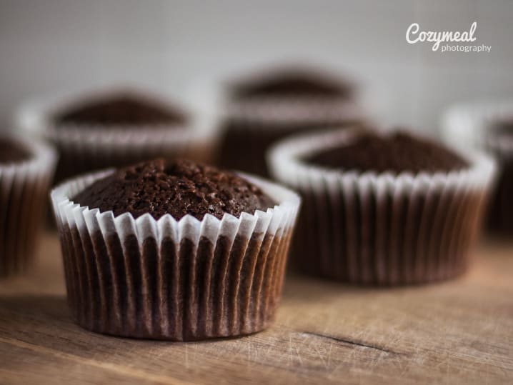 Dark chocolate cupcakes lined up, ready for serving