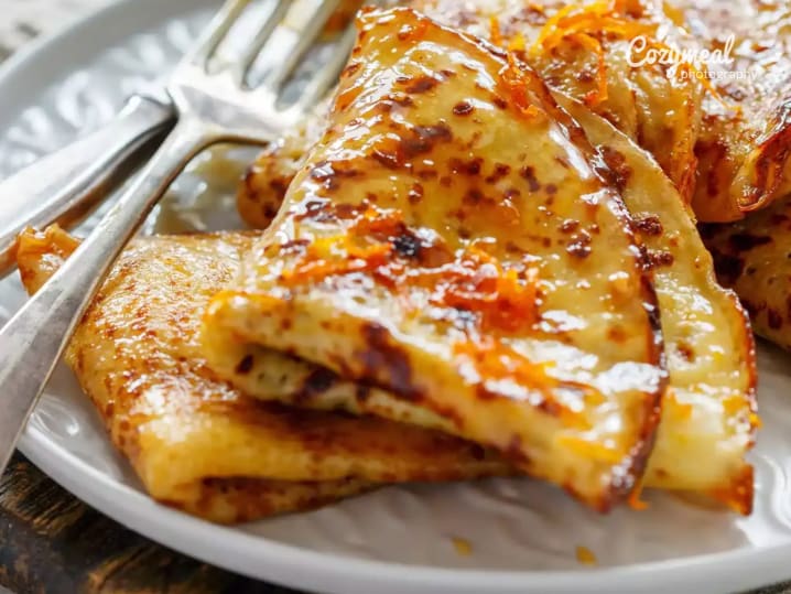 FlambeМЃed CreМ‚pes with Caramelized Orange and Brandy Sauce