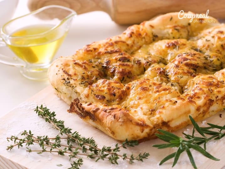 Flatbread garnished with herbs and oil