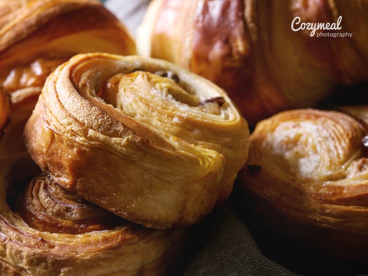 Freshly baked golden pastry buns with a glossy finish