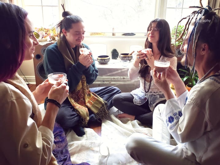 Friends gathered at cacao ceremony Canva