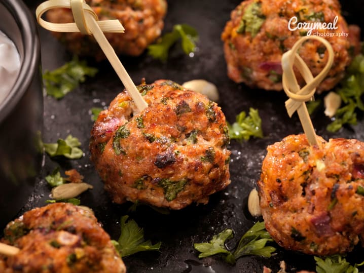 Skewers with golden brown meatballs garnished with parsley