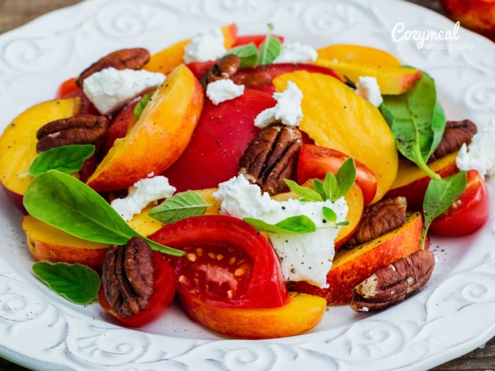 vibrant salad with peaches, strawberries and fresh greens