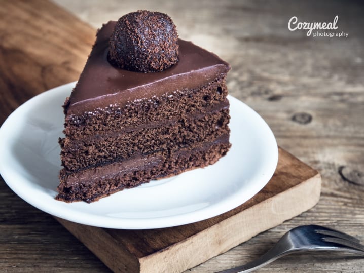 a piece of vegan chocolate ganache cake on a plate