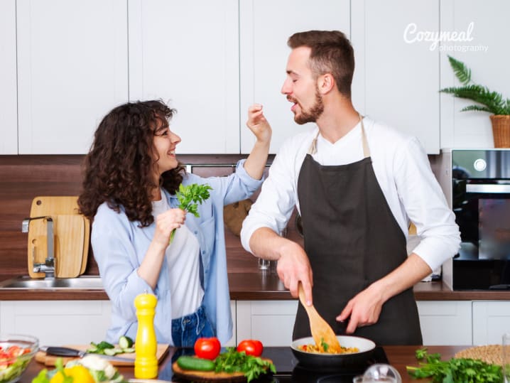 a couple having fun in the kitchen cooking together