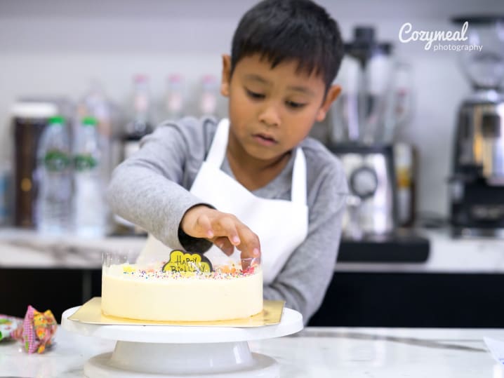 boy decorating cake