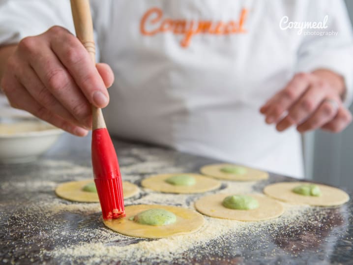 brushing herb filled ravioli