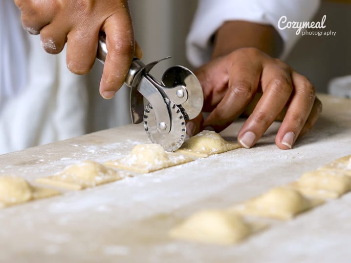 chef making homemade ravioli with ricotta and corn