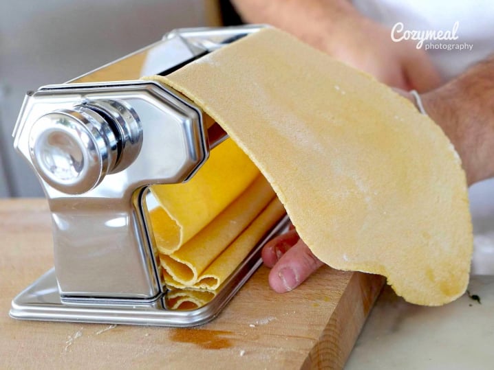 chef rolling out fresh pasta dough