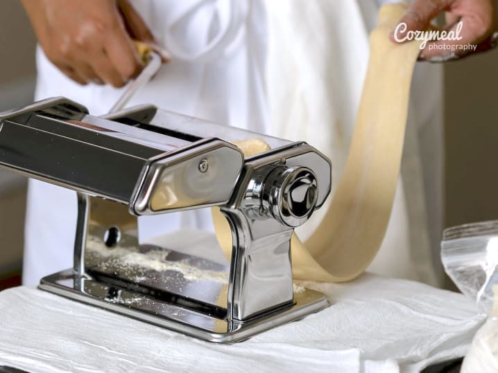 chef rolling out homemade pasta dough