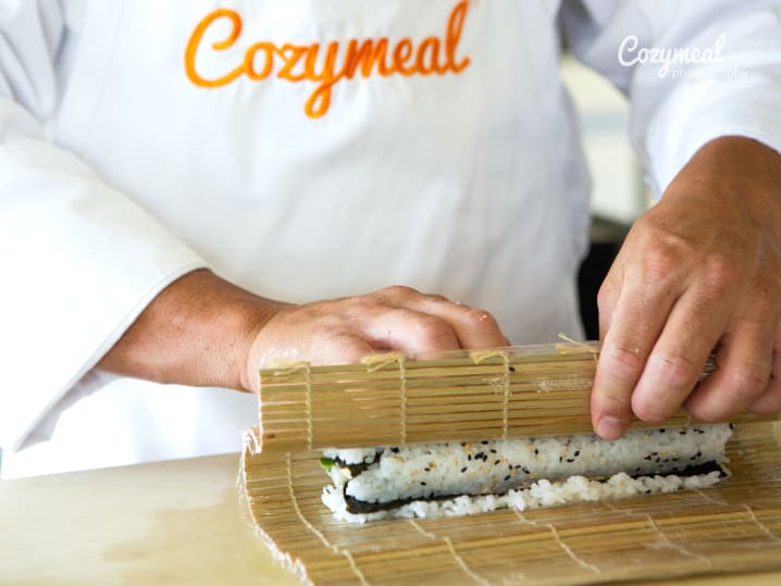 chef rolling sushi