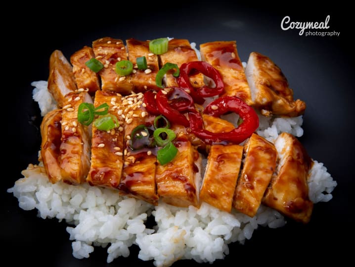 chicken Teriyaki on a bed of rice with scallop and chili garnish