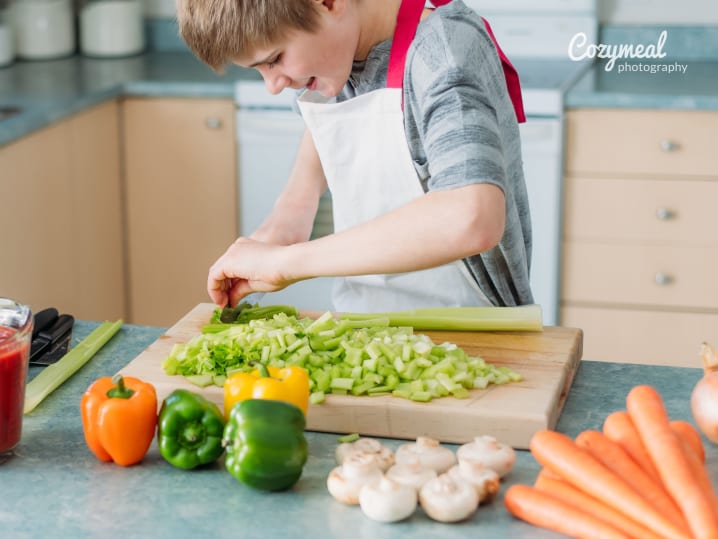 child cutting vegetables with precision