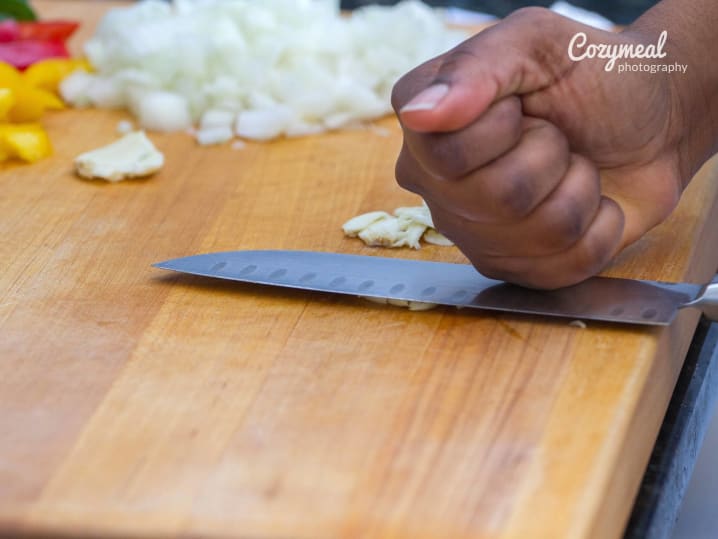 chopping peppers onions and garlic