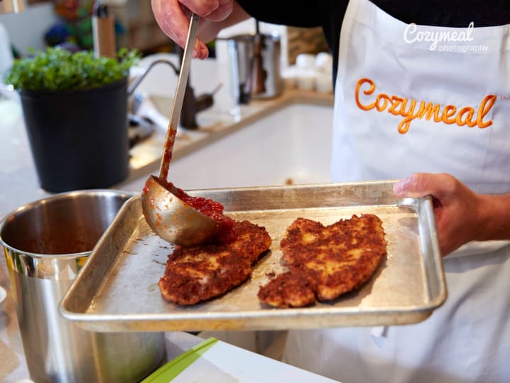 coating Chicken Milanese with marinara sauce