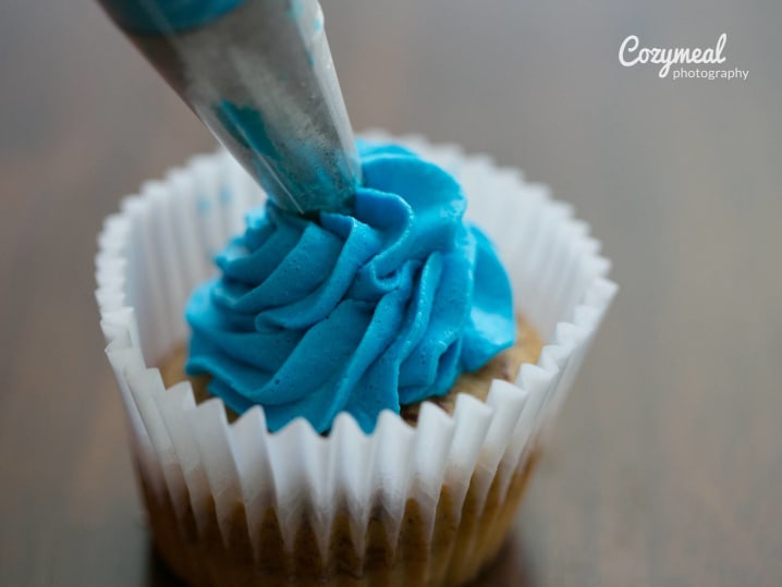 Piping icing onto cupcake