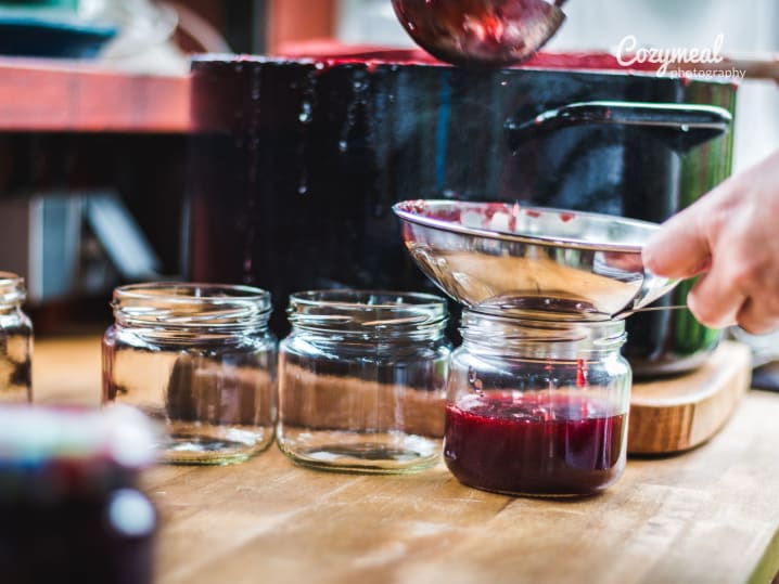 cooking fresh chutney and straining it into a jar