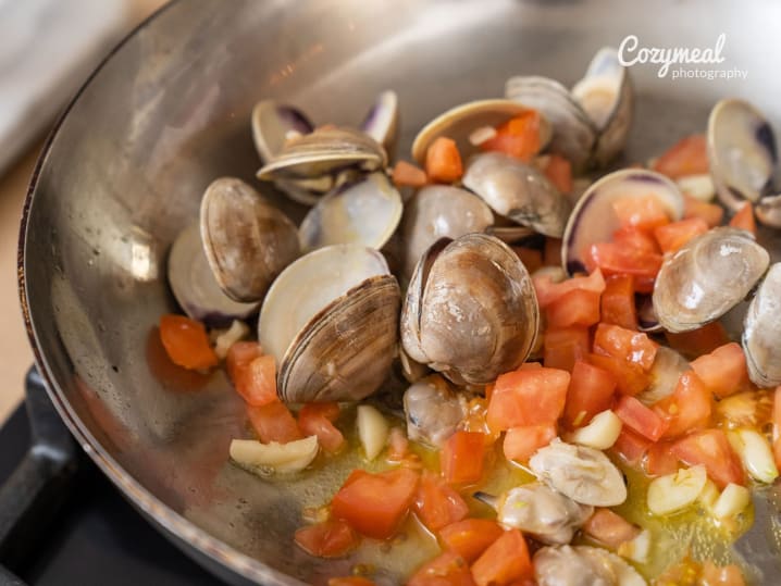 seafood cooking with vegetables in pan for bouillabaisse preparation