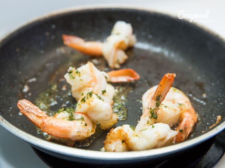 shrimp cooking with butter in black pan