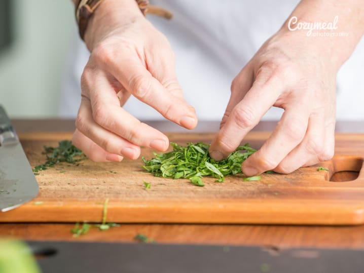 close up of chef cutting basil leaves