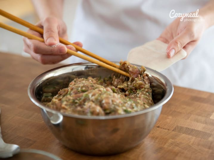 adding filling to dumplings