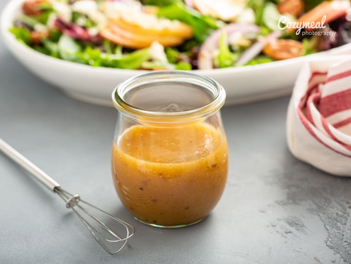 fresh vinaigrette sauce with salad in the background