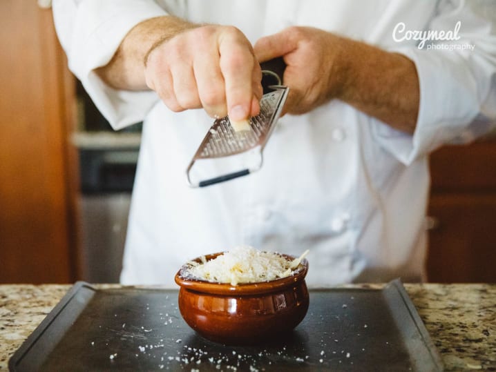 grating cheese over onion soup