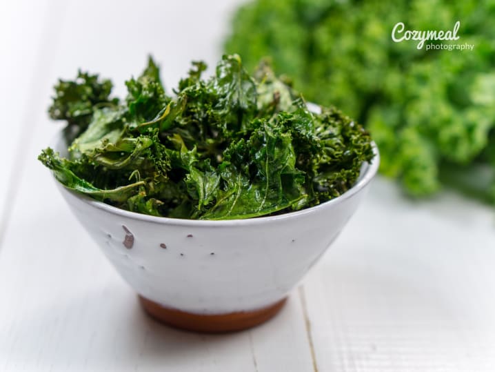 fresh kale salad served in white bowl