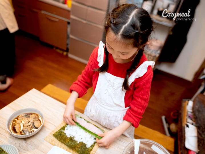 kid making homemade sushi