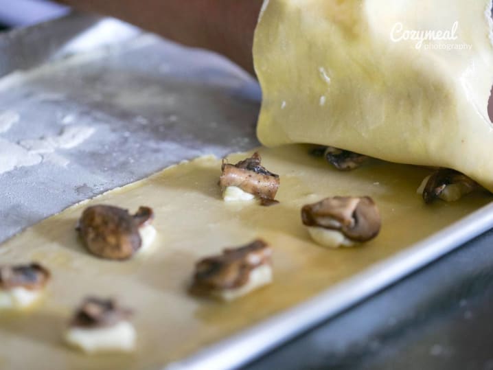 making ricotta and mushroom ravioli