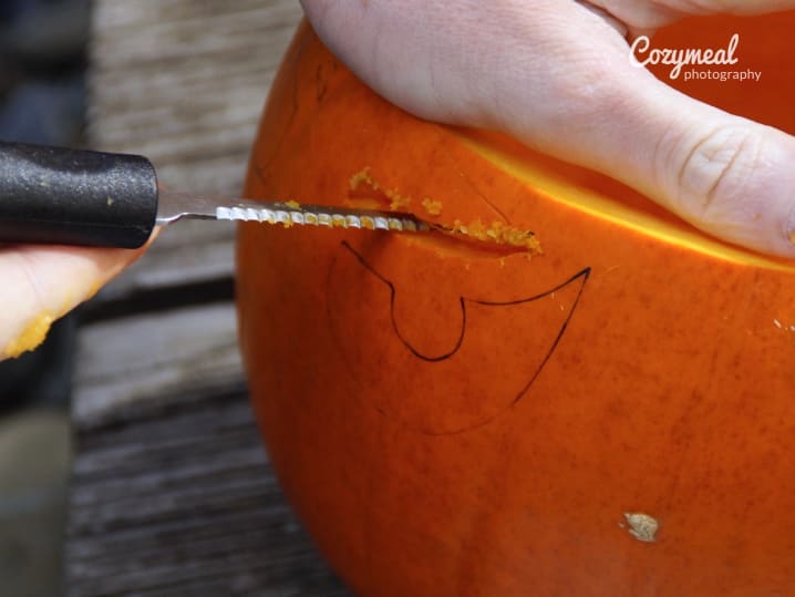 man carving a pumpkin