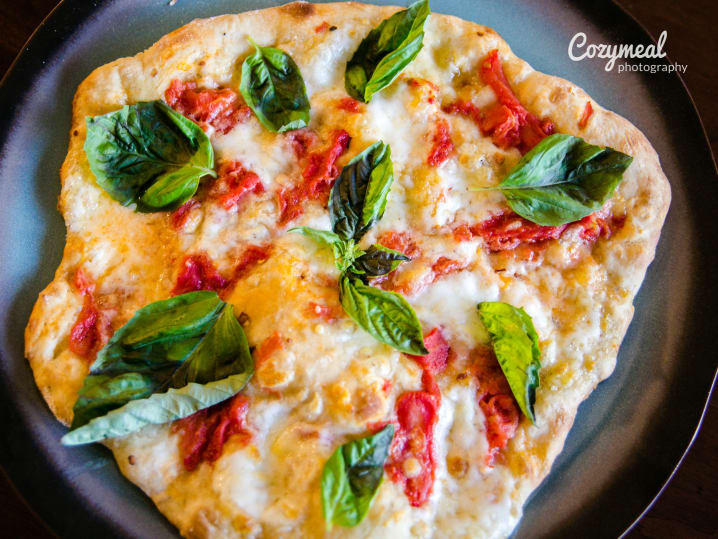 margherita pizza with basil tomatoes and mozzarella