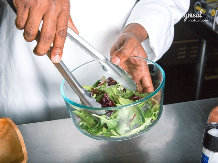 mixing Arugula salad