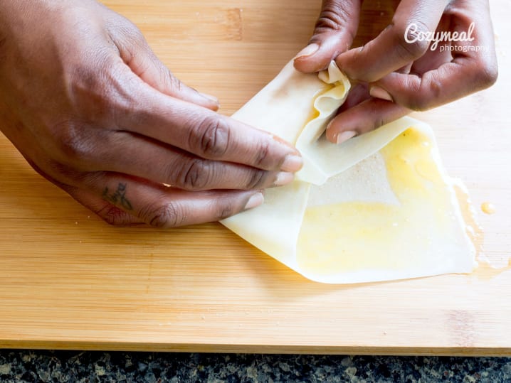 person making eggrolls