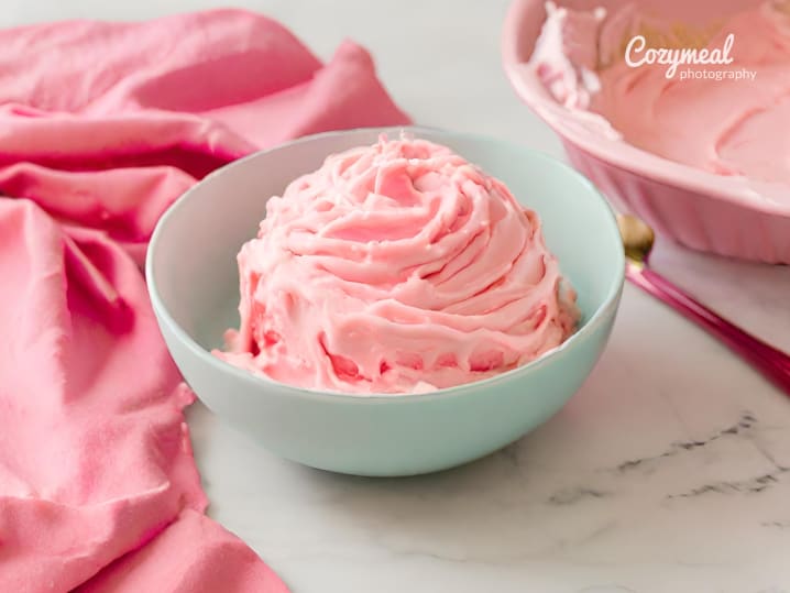 pink cake icing in bowl