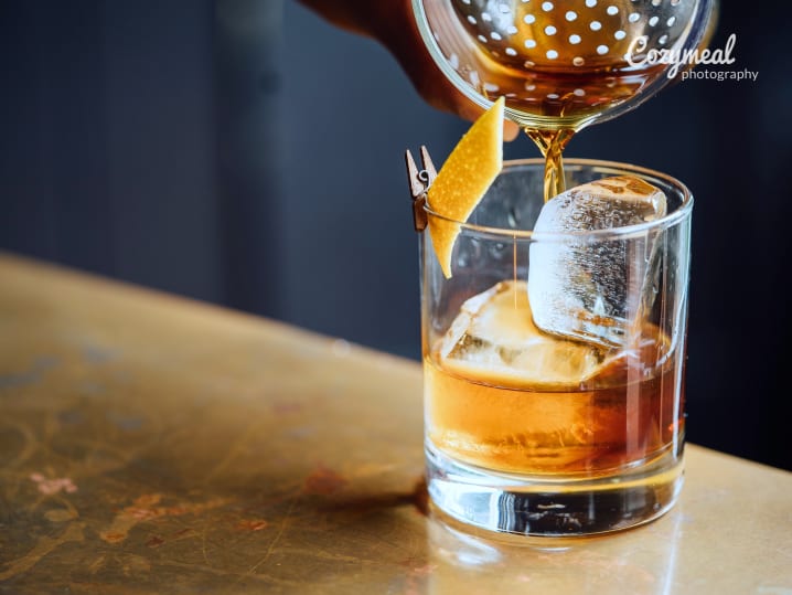 pouring an old fashioned cocktail