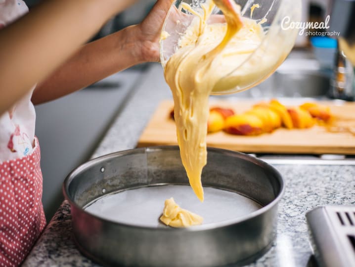 a teen girl is pouring batter into a baking tray