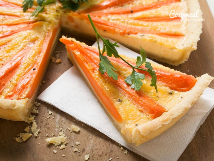 roasted carrot tart sliced and served on wooden board
