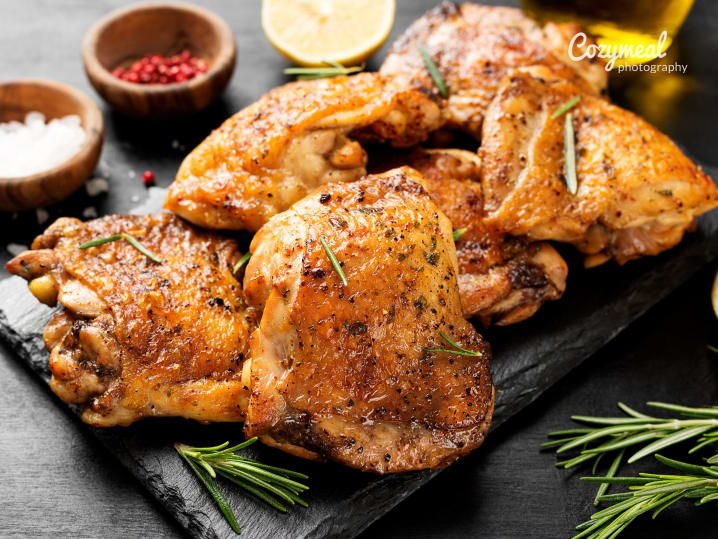roasted chicken quarters with crispy finish and rosemary on the side