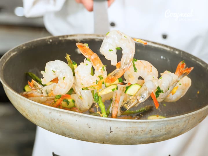 sauteeing shrimp in a pan