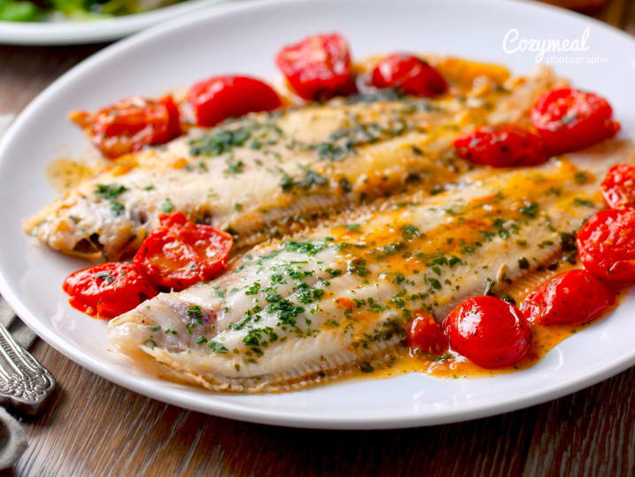 sea bream fish with green seasoning and tomatoes