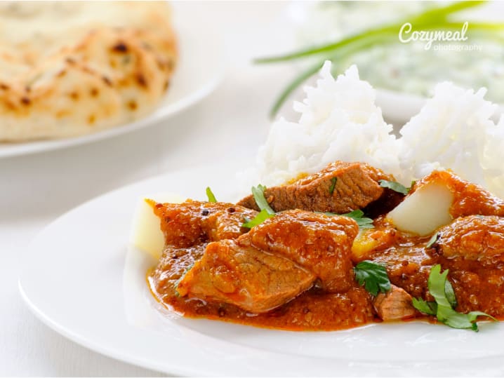 spicy lamb curry with rice and naan bread
