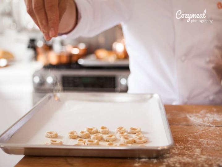 sprinkling fresh Orecchiette pasta with flour