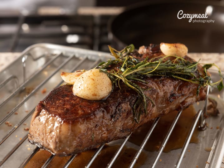 steak with butter over a rack